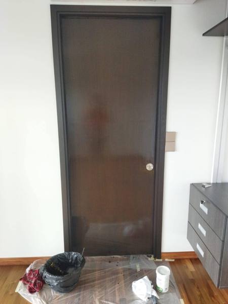 Door varnishing in progress, floor protected
