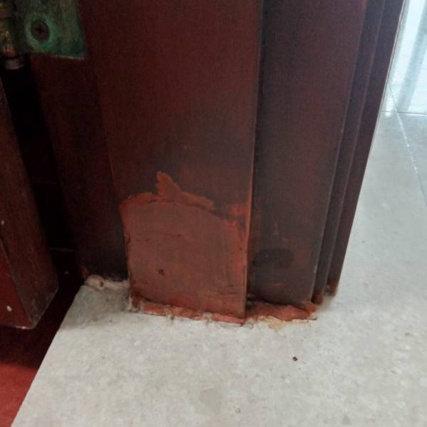 Door frame bottom being rebuilt with filler during repair
