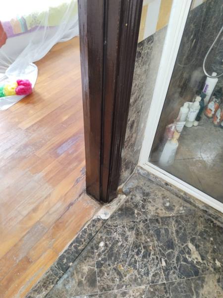 Door frame bottom rebuilt and varnished after repair