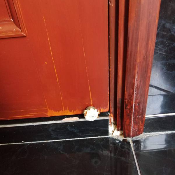 Swollen and split door frame bottom before repair