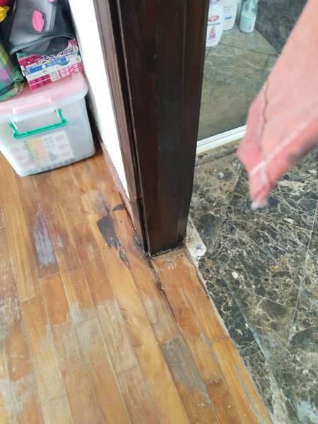 Door frame bottom repaired at marble threshold