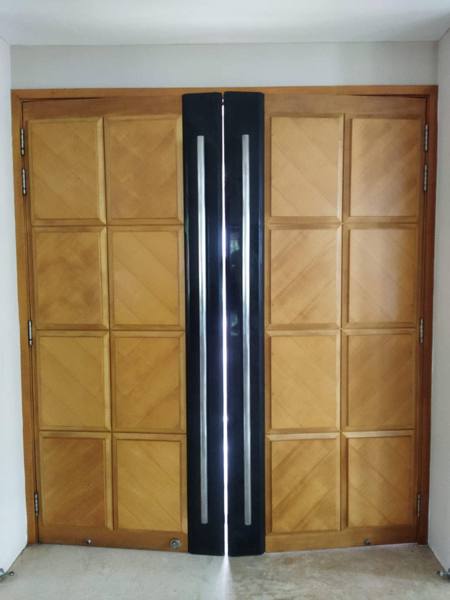 Faded double teak main door before varnishing