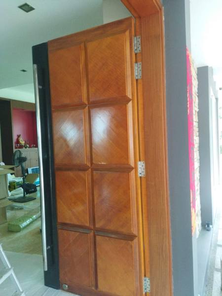 Teak pivot door after